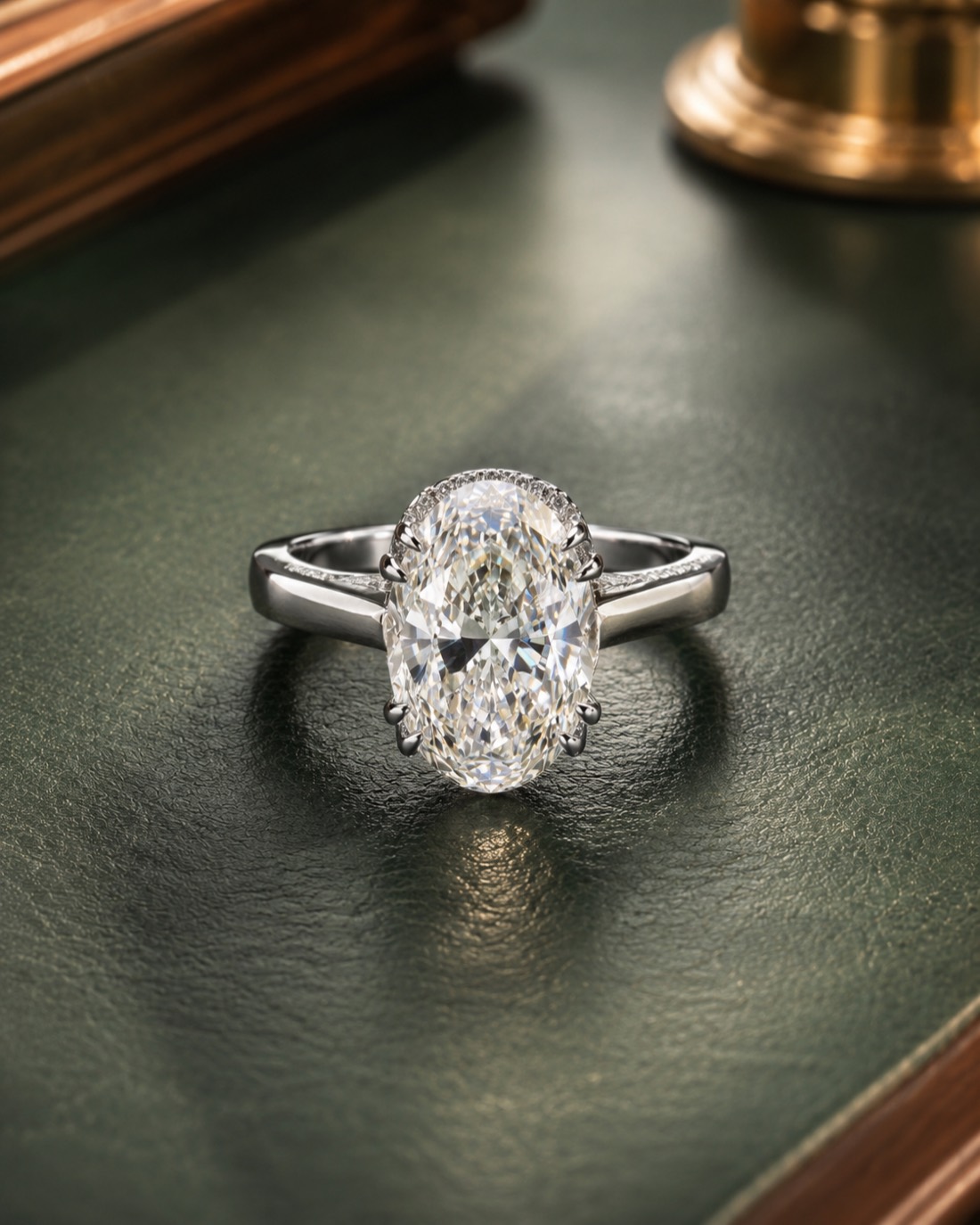 The Celeste Oval — a 3.5 carat oval diamond engagement ring in platinum, photographed in warm candlelight