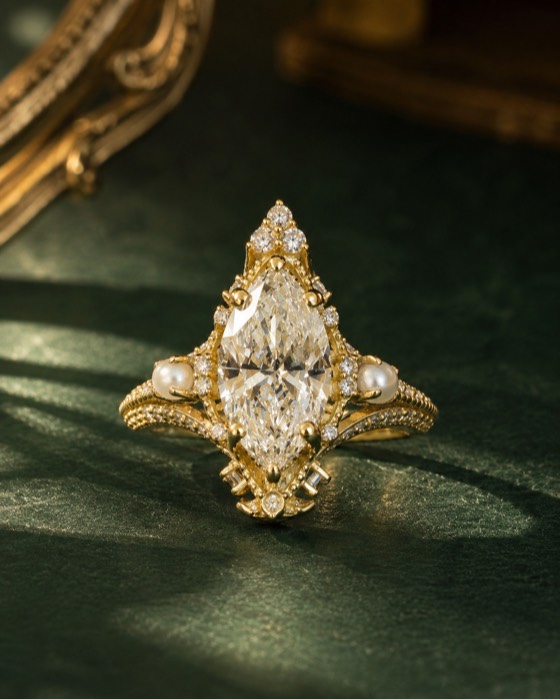 The Magnolia — an elongated marquise diamond ring in yellow gold with pearls and milgrain