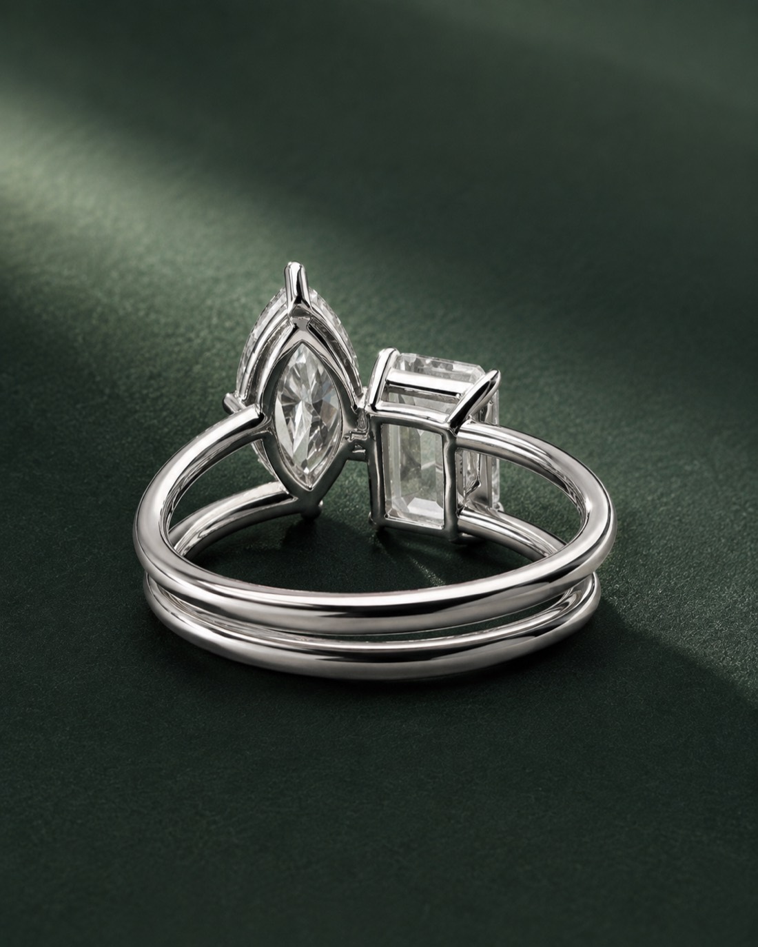 The Meridian Duet — a two-stone engagement ring pairing a 2 carat marquise and a 2 carat emerald cut diamond in platinum
